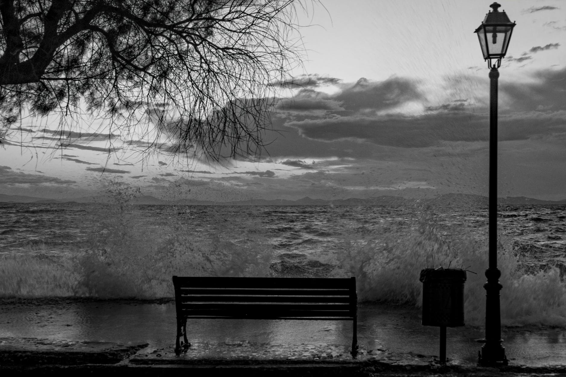 bench black and white storm waves
